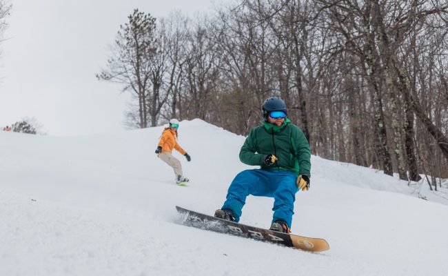 Man and woman on snowboards