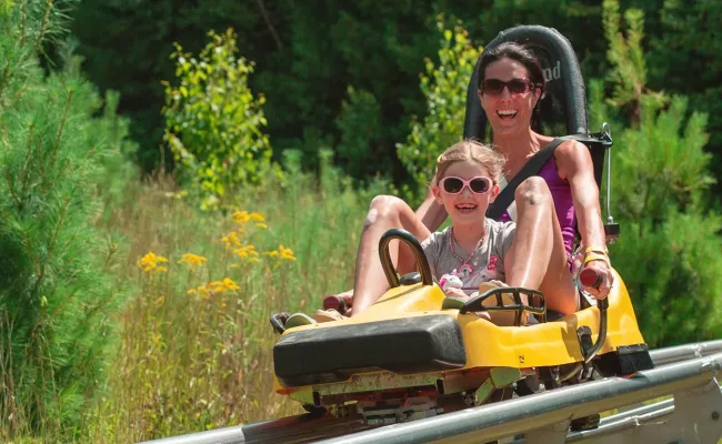 Mother and daughter on mountain coaster