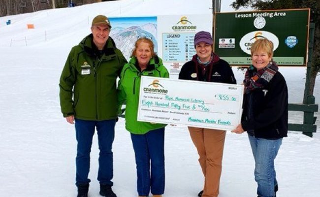 Ben Wilcox and Karen Dolan presenting check to Pope Memorial Library