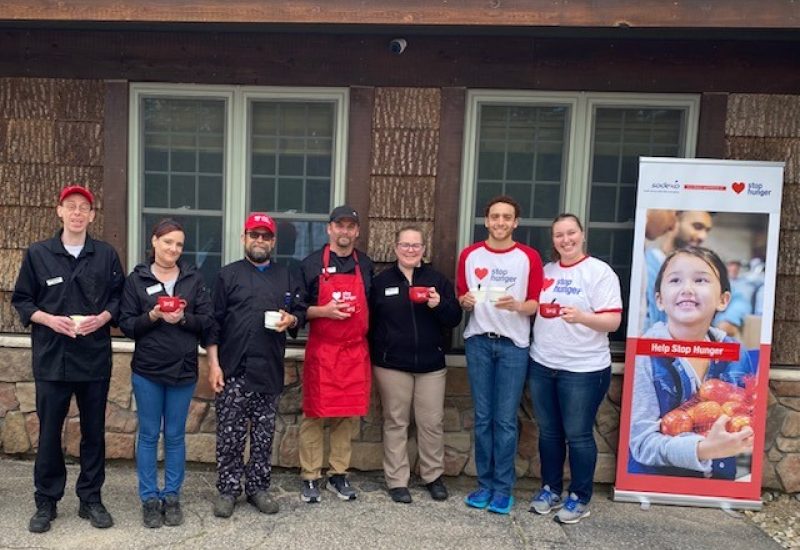 Food Service employees with Stop Hunger banner