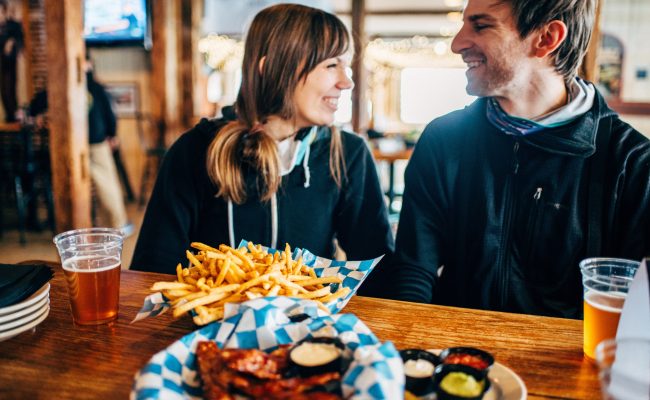 couple with food and drinks in Zips Pub