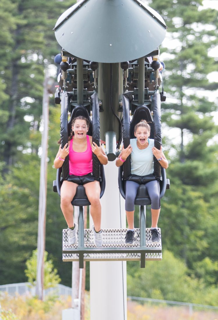 Girls riding giant swing
