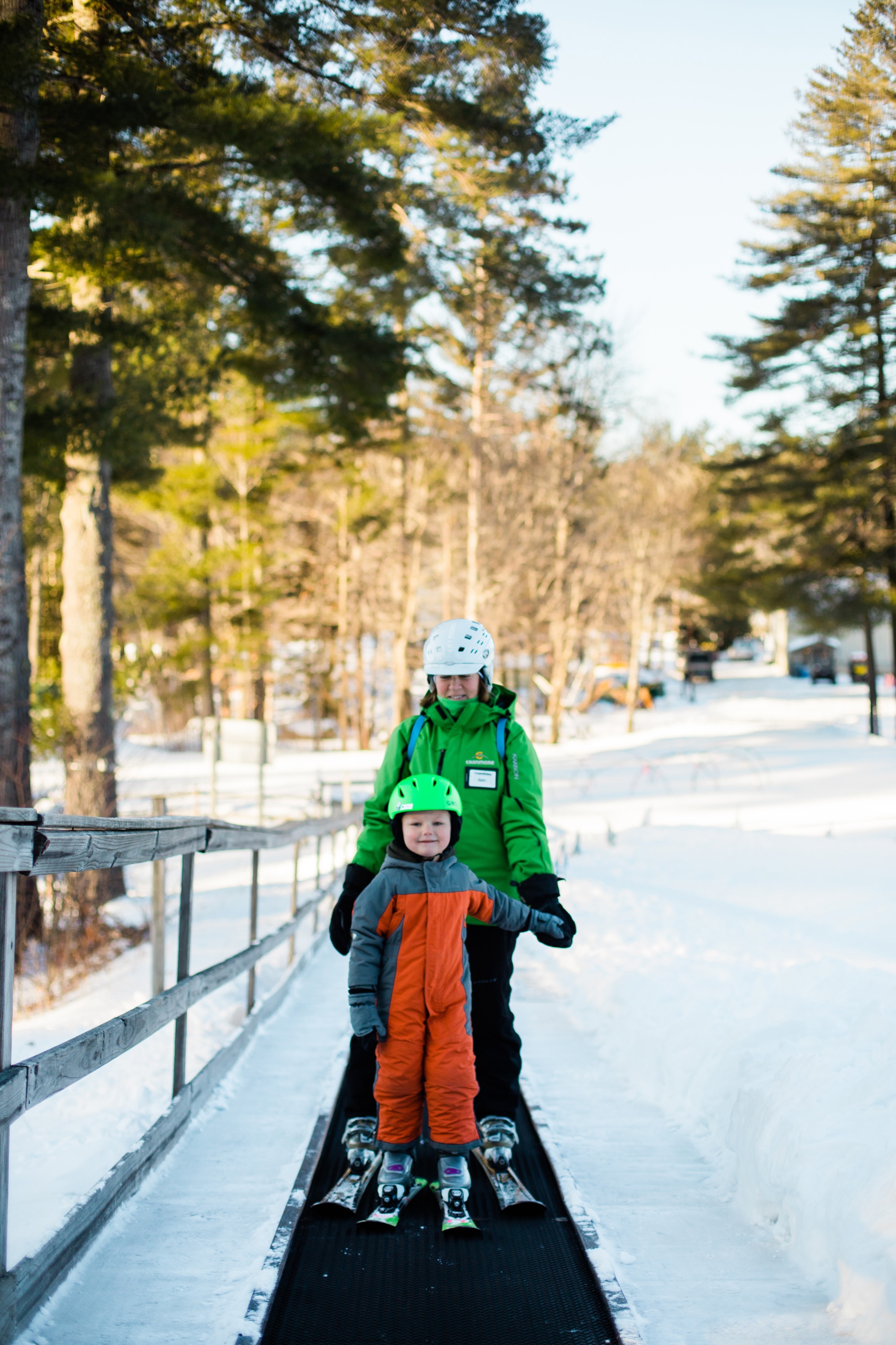 child and instructor riding the magic carpet